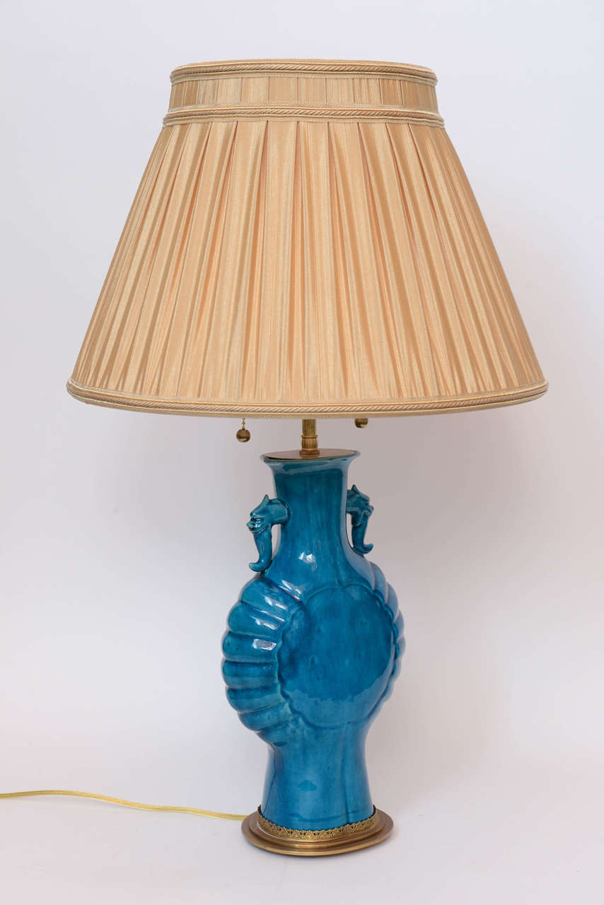 A pair of Chinese porcelain turquoise glazed oviform lamps with dragon handles, 19th century.