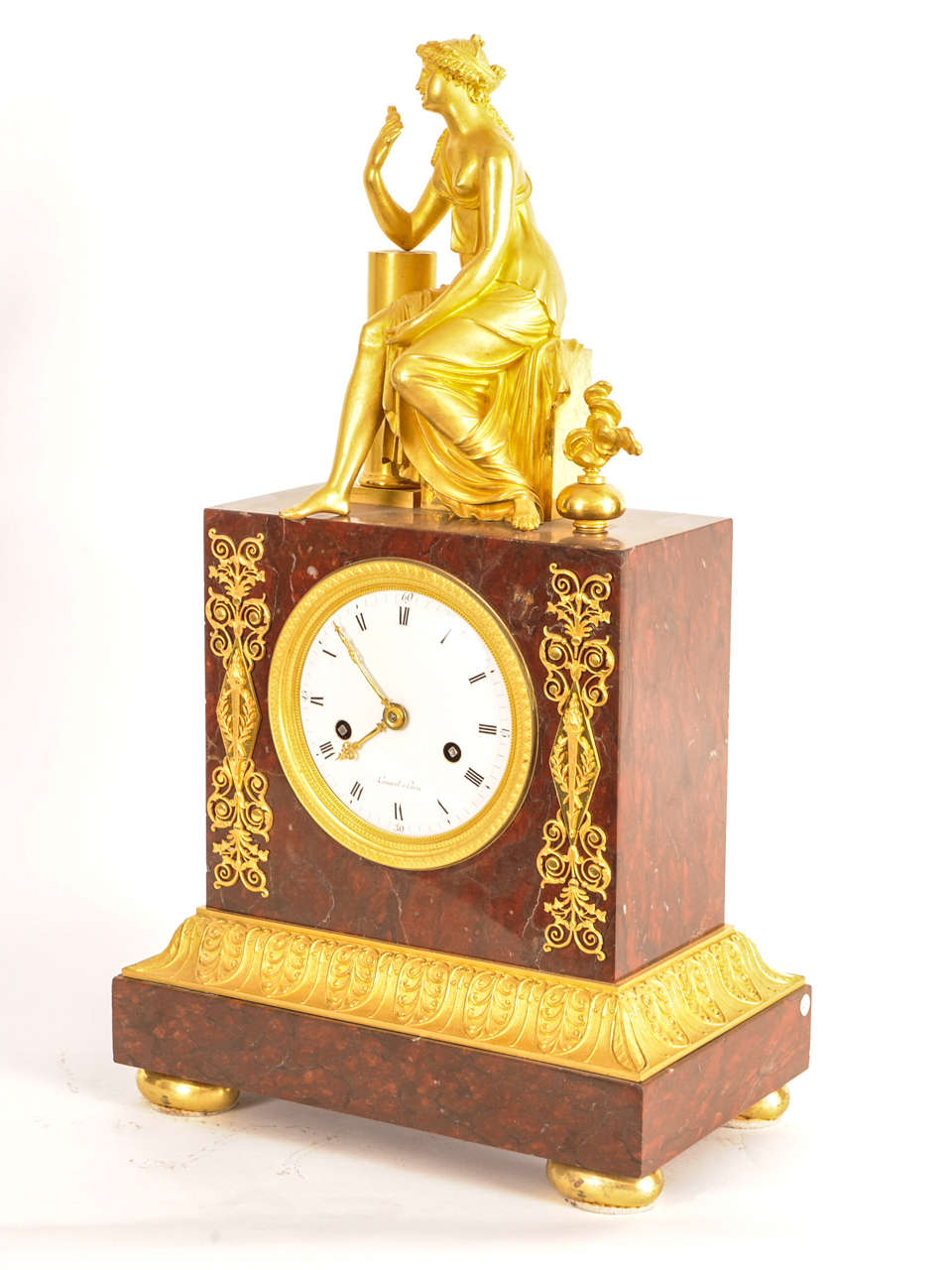 striking, with the figure of a seated woman on top, the dial signed 'Lamiral A Paris'.