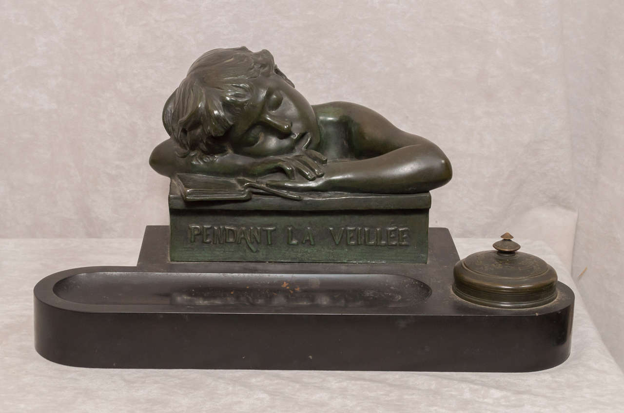 Artist signed Joachin Angles .Joaquin Angles, 1859-1905, France, figural bronze and marble inkwell, the sleeping young boy resting on his book bronze sets on a black marble base with front pen slot and bronze capped inkwell, the boy figure is signed