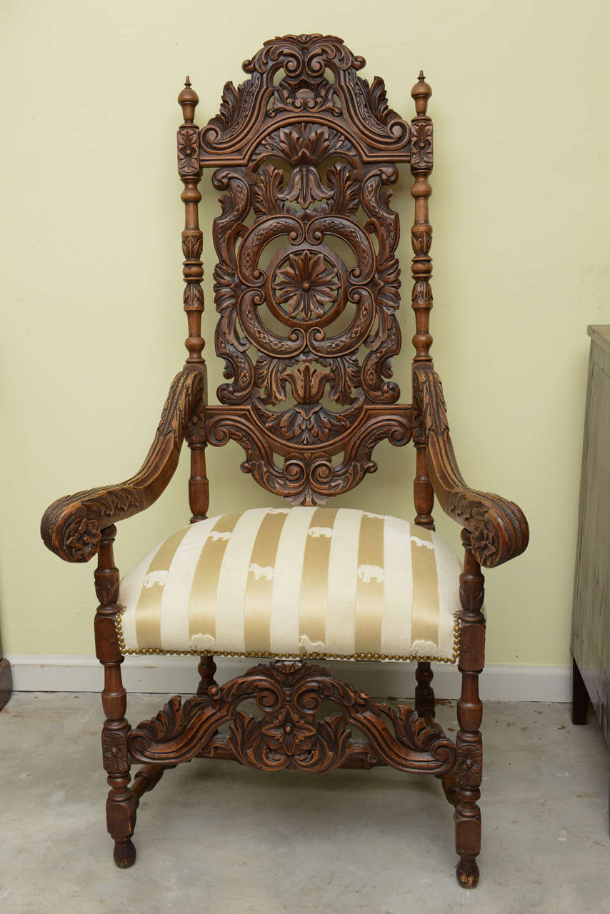 This is a superb profusely carved arm chair, the seat has just been recovered. The patina is all original and has a very nice brown color.