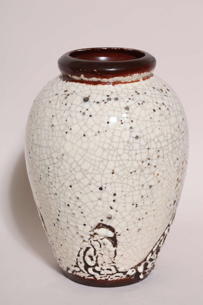 This large white craqueleur vase has an abstract design around the base with the white 