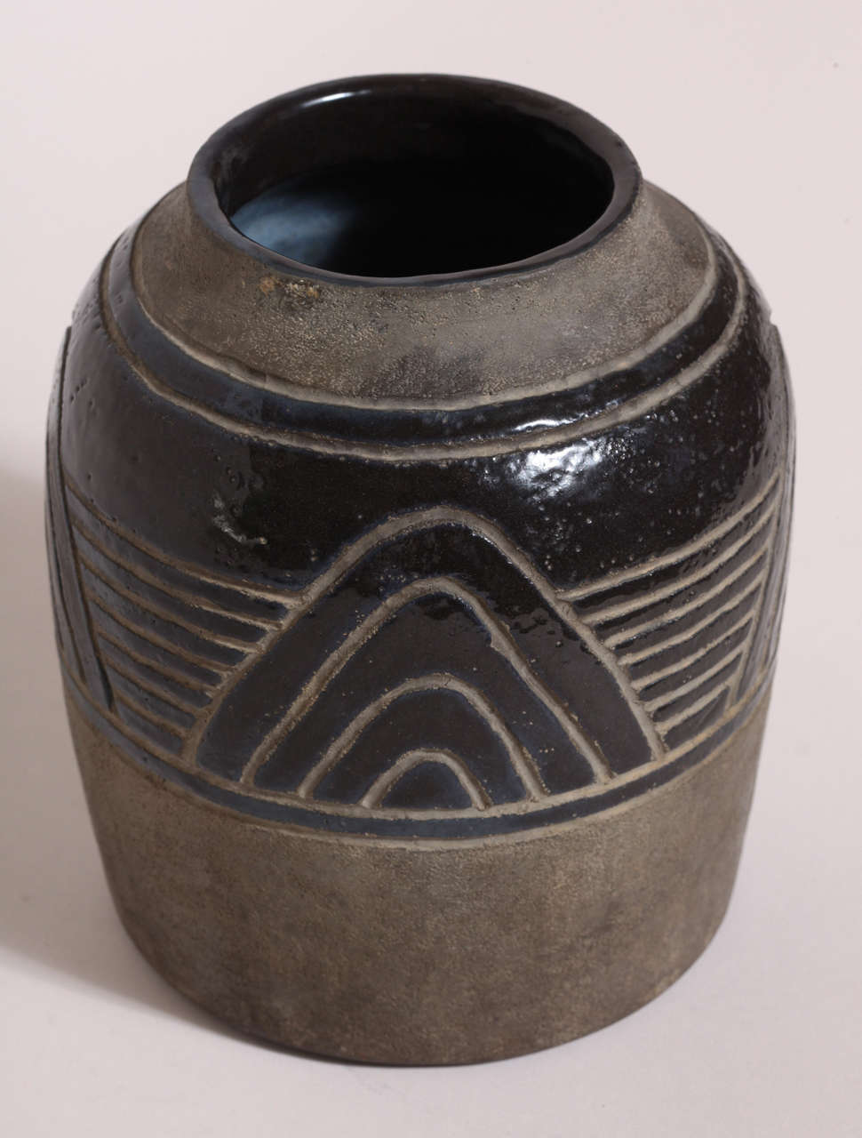 A cylindrical stoneware vase partially glazed black with an incised geometric design.
Signed: H Sim.

(Price shown is reduced price, no further trade discount) 