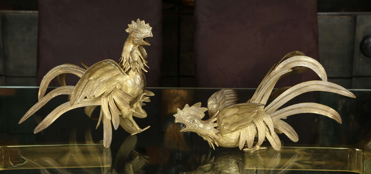 Pair of fighting game cocks in brass.   The details are meticulously finished