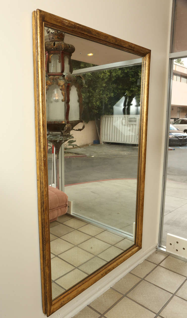 Large mirror with a gilded wooden frame