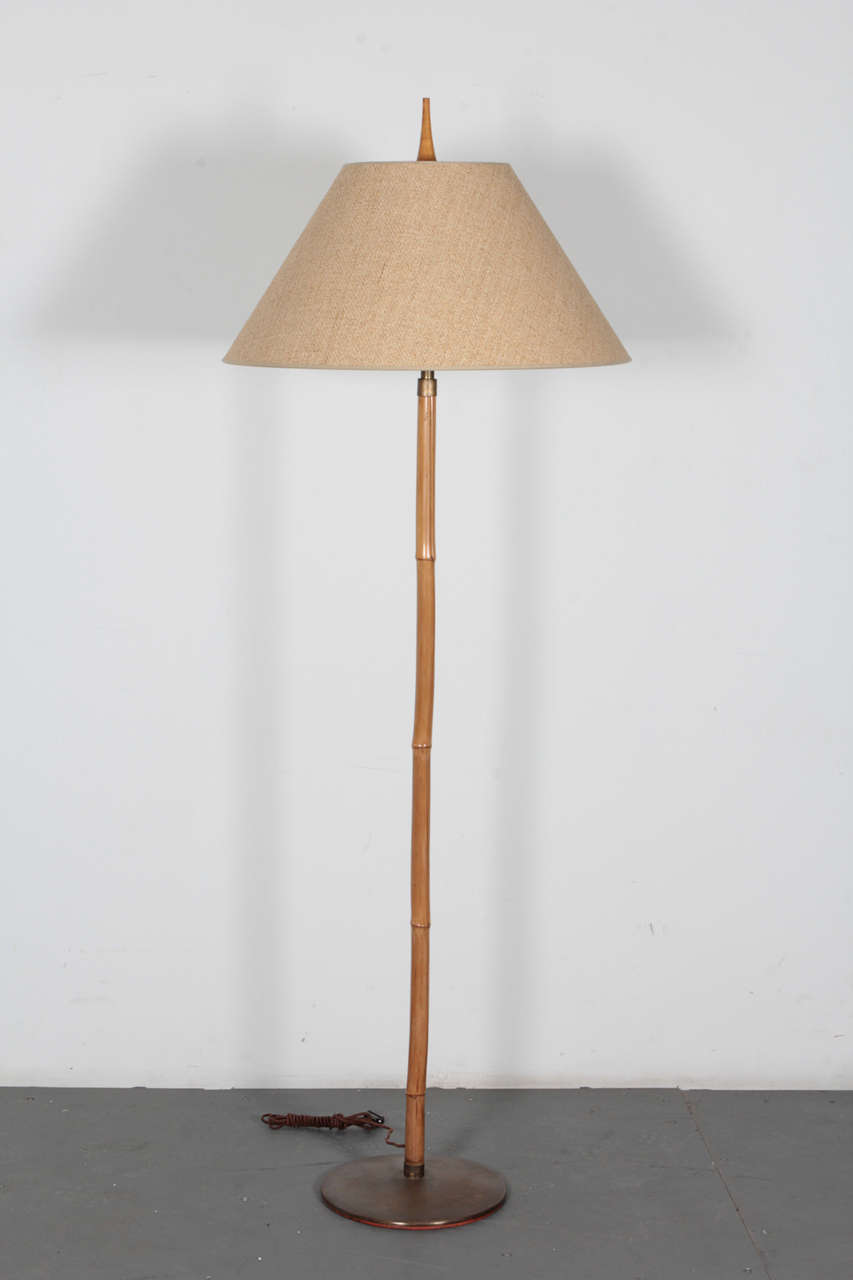 Bamboo floorlamp on a bronze base with a conical burlap shade; in the style of Carl Aubock. Austria, 1950's. Base diameter is 12 1/4 inches.