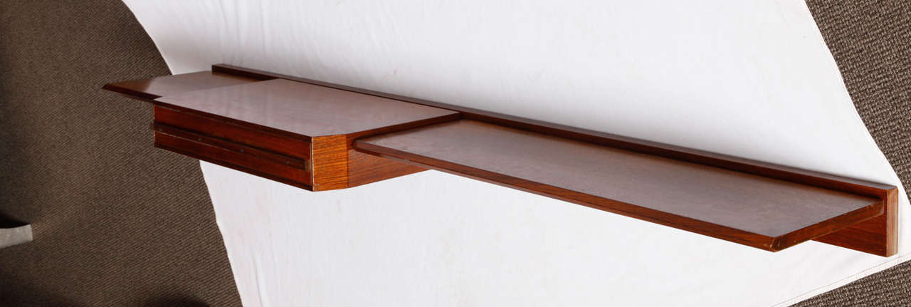 Dark rosewood veneered console table -shelf with one drawer is the middle.
It needs to be fixed on the wall.Stamped Dino Cavalli Tredici & C.Italy.
