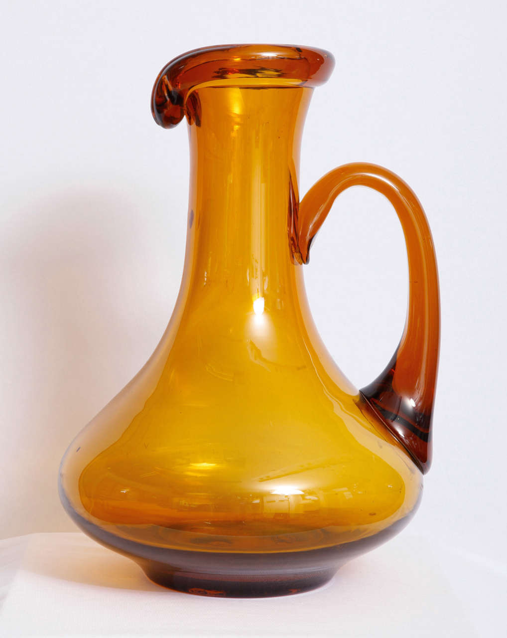 Monumental decorative jug in amber glass made in Empoli, Italy, well known city for its glass factories.