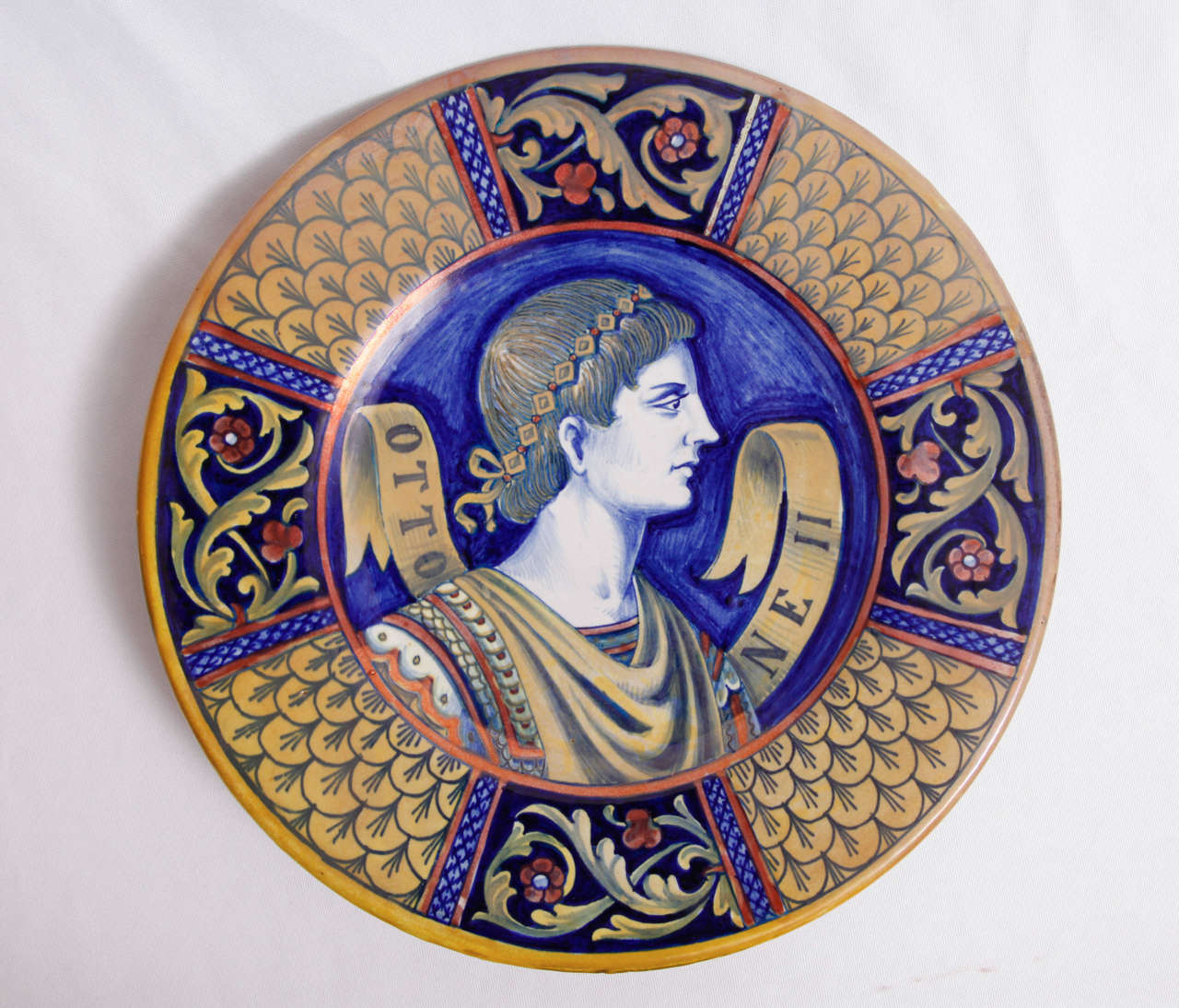 A pair of Italian polychrome ceramic (wall) platters with historical figures executed by Lorenzo Rubboli.
