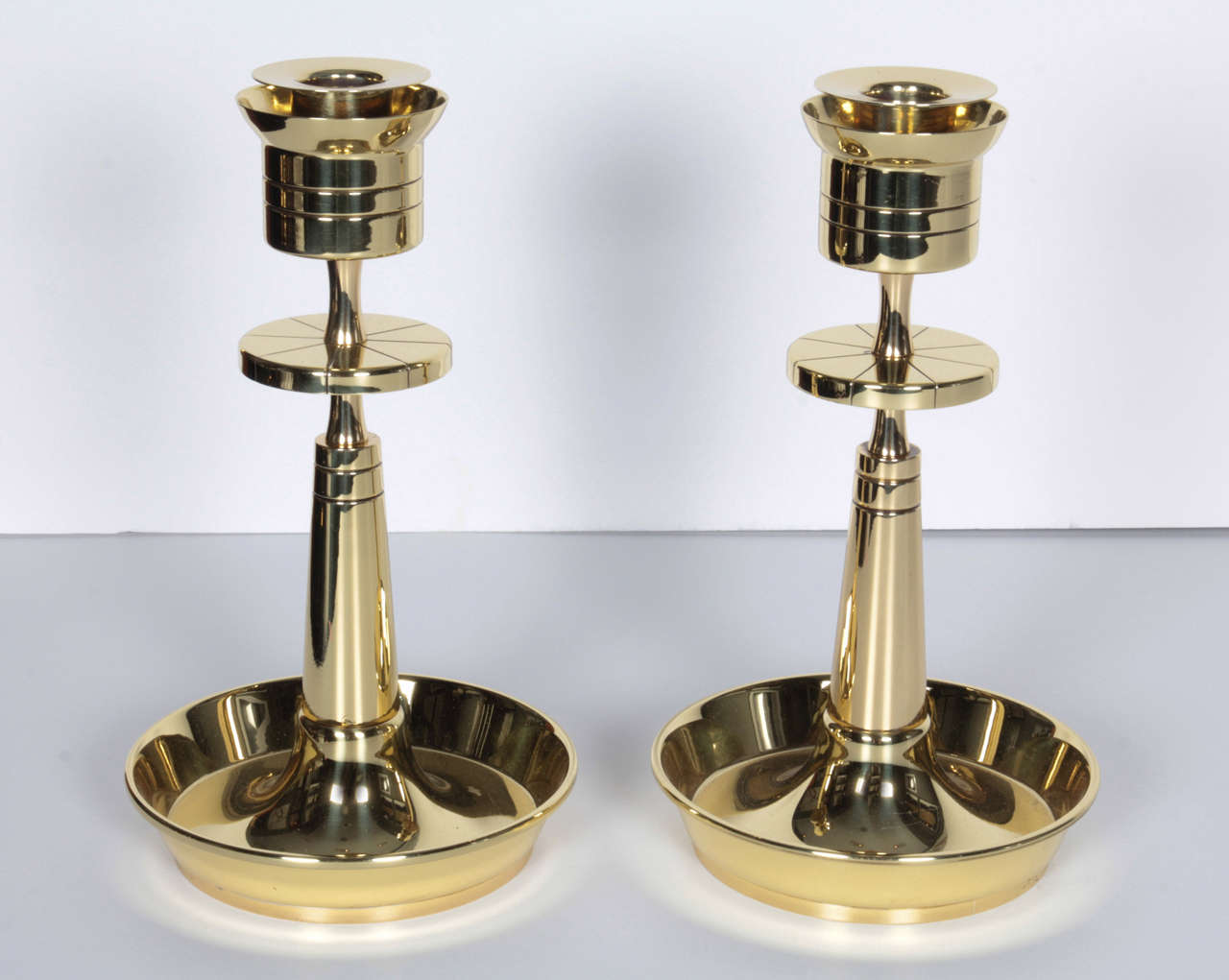 A stunning pair of brass candleholders by Tommi Parzinger for Dorlyn.