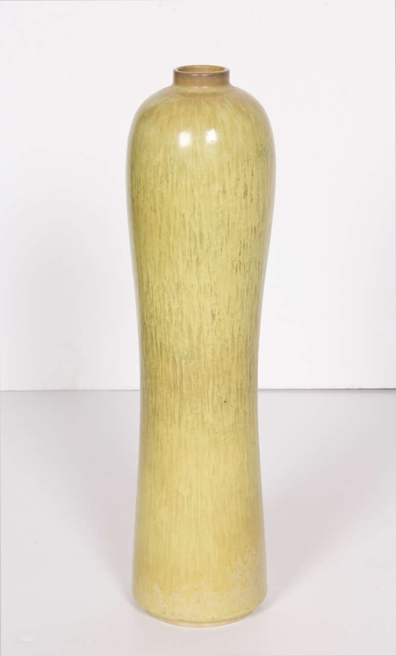 A beautifully glazed ceramic vase by Gunnar Nylund in tones of chartreuse and olive. Maker's mark and signature on bottom.
