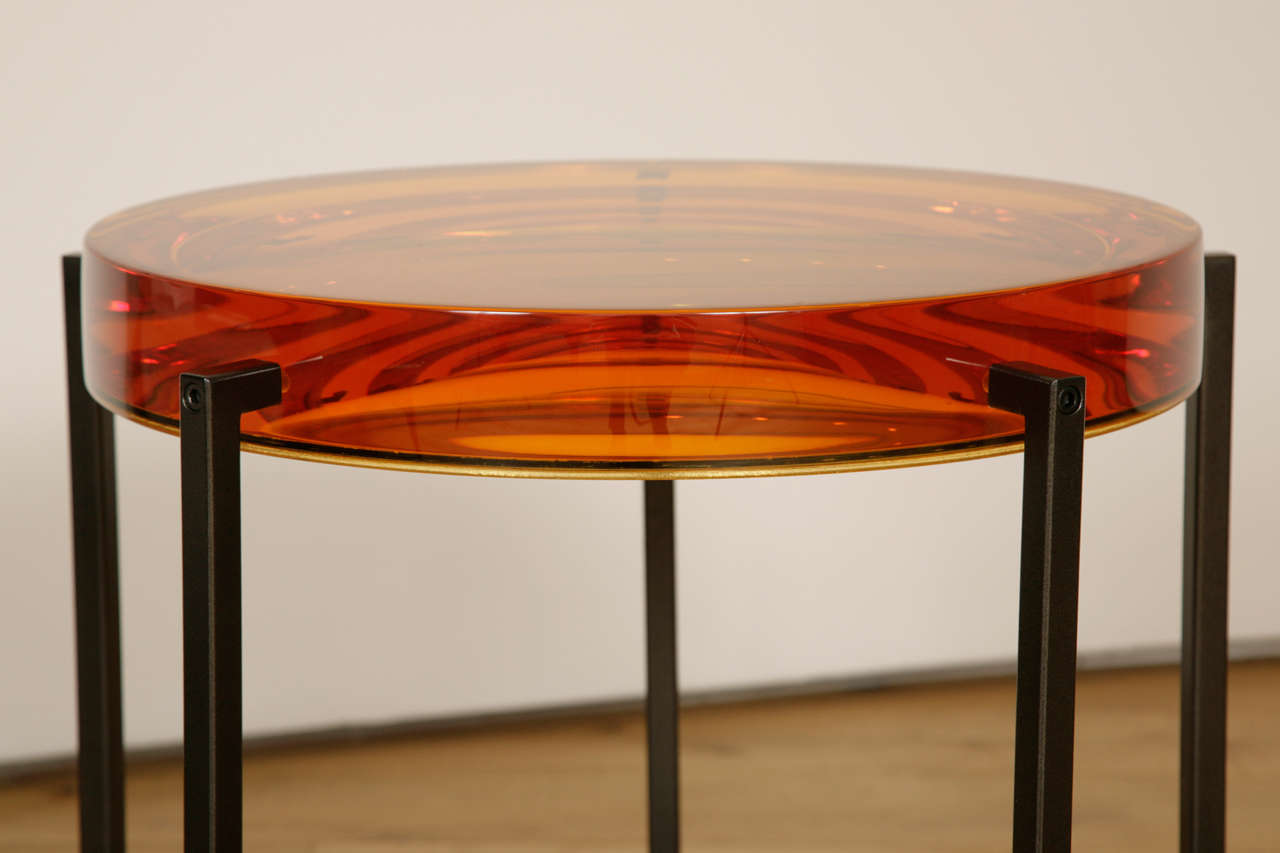 British, 2014.
Cast amber-tinted resin backed by acrylic mirror,
On black patinated metal legs.