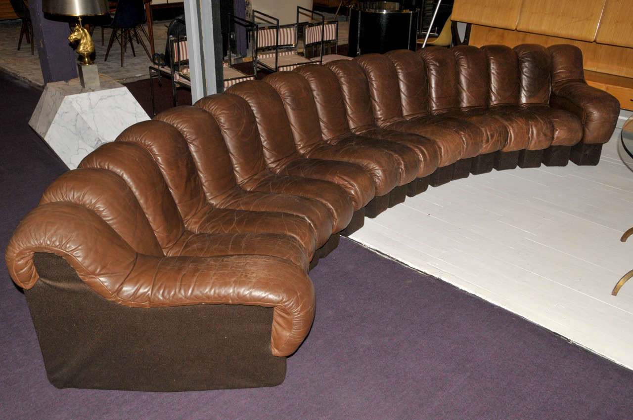 1970's 'DS600' model sofa by De Sede. Brown leather and fabric. 17 elements. Normal wear consistent with age and use.