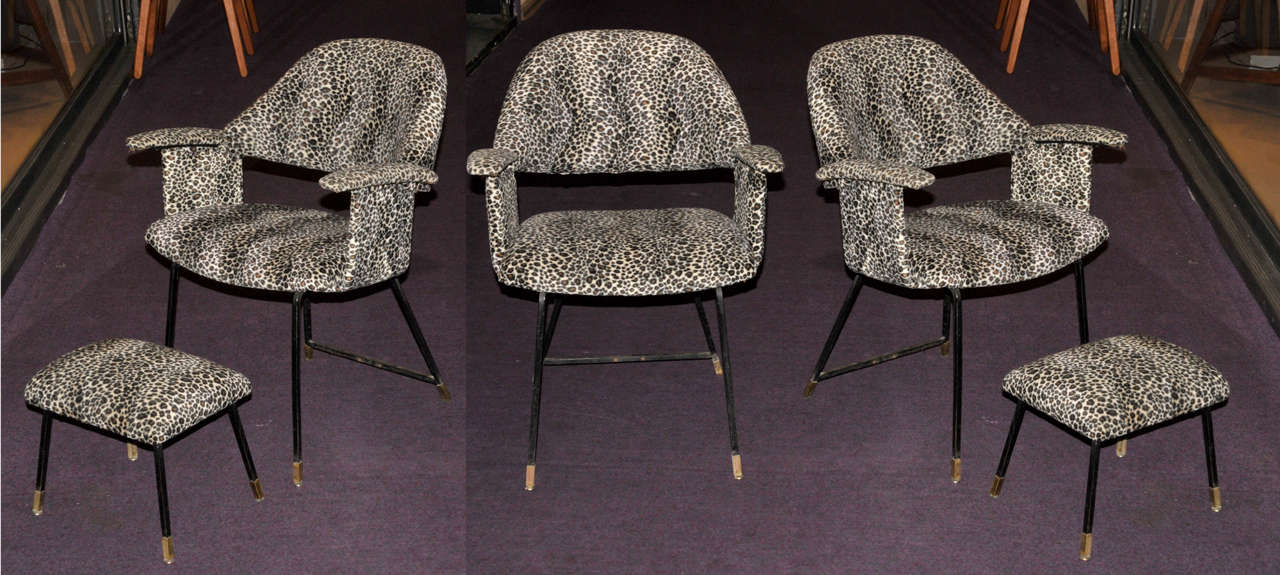 Four 1970's armchairs and two footstools covered with leopard like fabric (non original). Black lacquered metal structure and brass feet. Good condition. Normal wear consistent with age and use. 

Armchair dimension: Height 76cm x Seat height 40 x