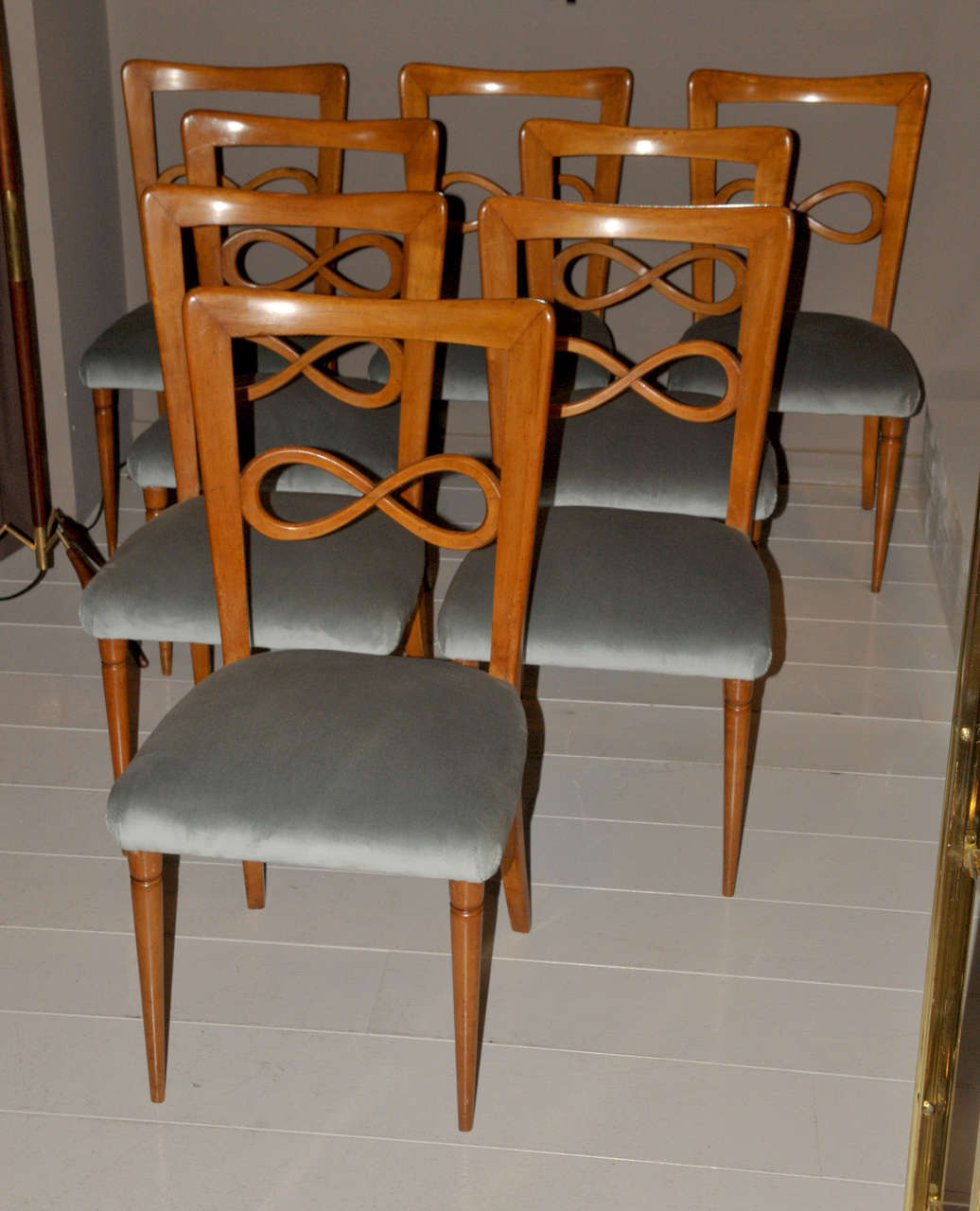 Set of eight 1950's Italian chairs in walnut with grey-blue velvet (non original). Good condition. Normal wear consistent with age and use.