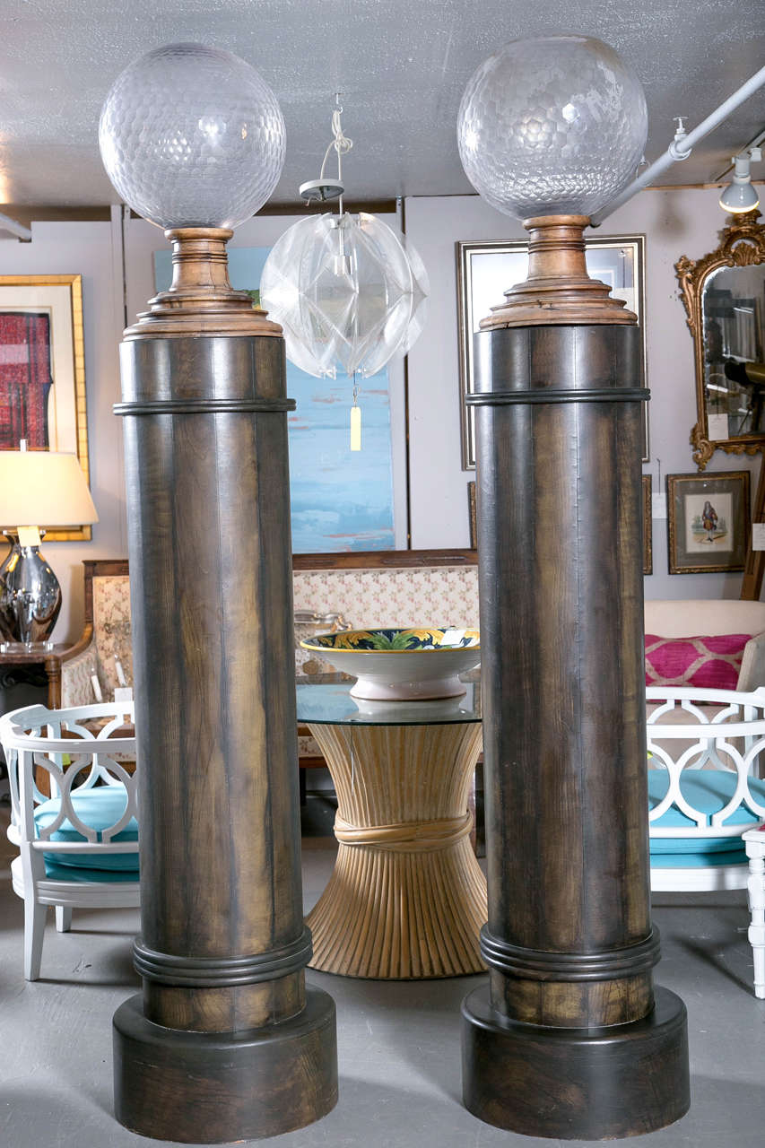 Pair of monumental wooden colums with large, heavy cut glass finials. Great standing alone but a notch in back allows them to be vonverted to lighting outlets.