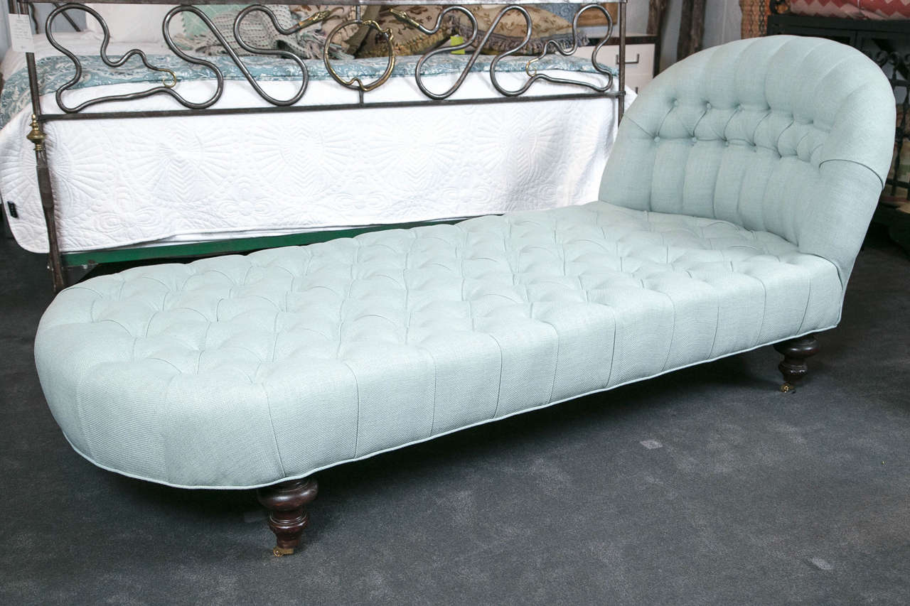 Grand scale with new sea-foam linen upholstery, button tufting and mahogany feet with brass castors allows this spectacular piece to be a welcomed asset into any home.