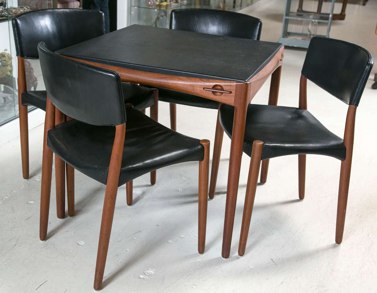 This set of 4 chairs and game table are the perfect combination of sophisticated, and sleek. Aksel Bender Madsen and Ejner Larsen set out to create their own studio in 1947. The same year they collaborated with cabinetmaker Willy Beck at the