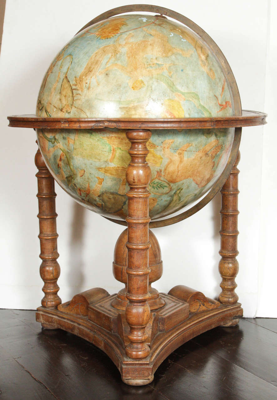 Unique, large, hand-painted, Italian, metal globe featuring the 12 signs of the zodiac. The whole set into a hand-carved base with turned legs.