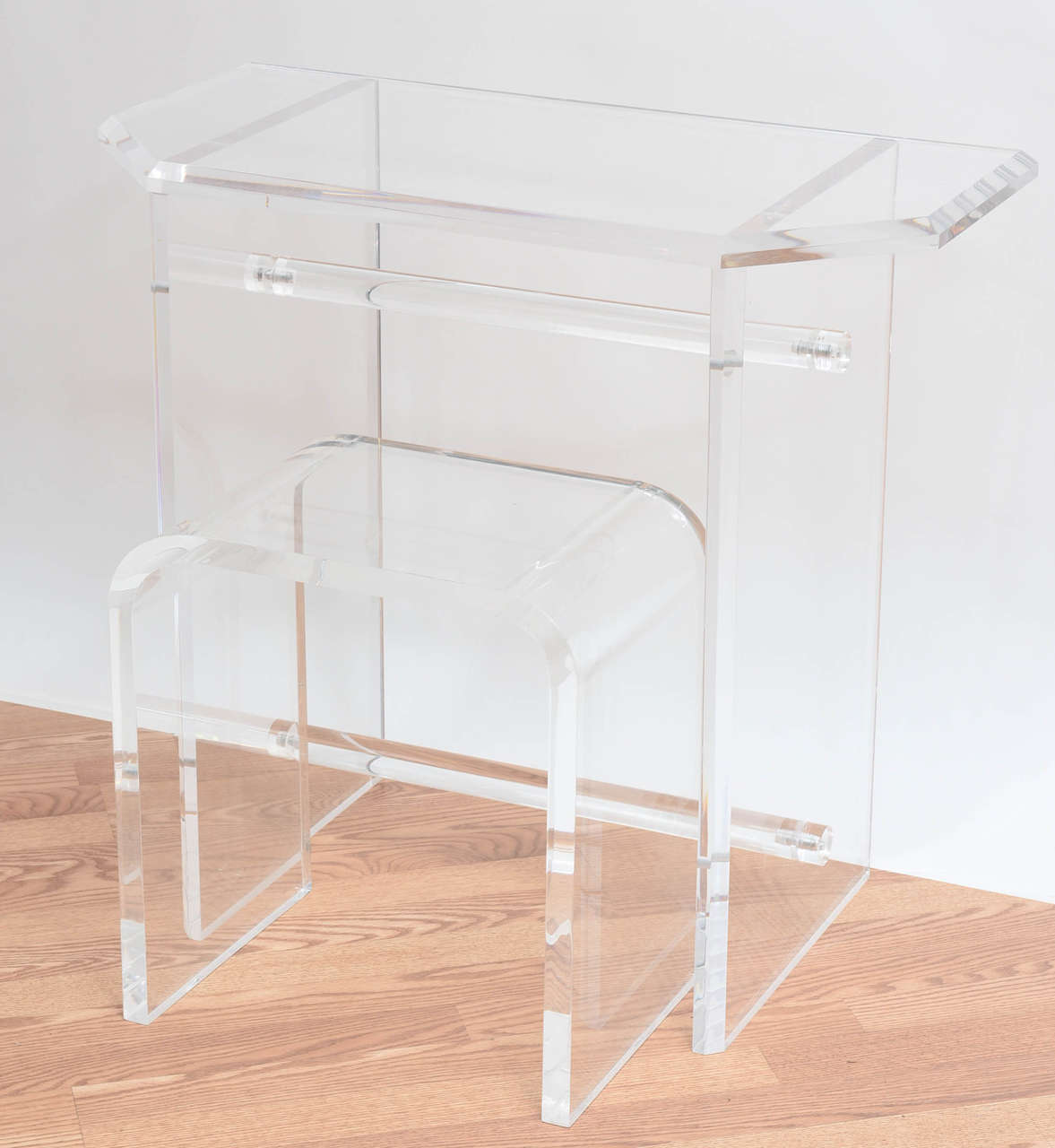 Chic Lucite vanity table with waterfall seat.