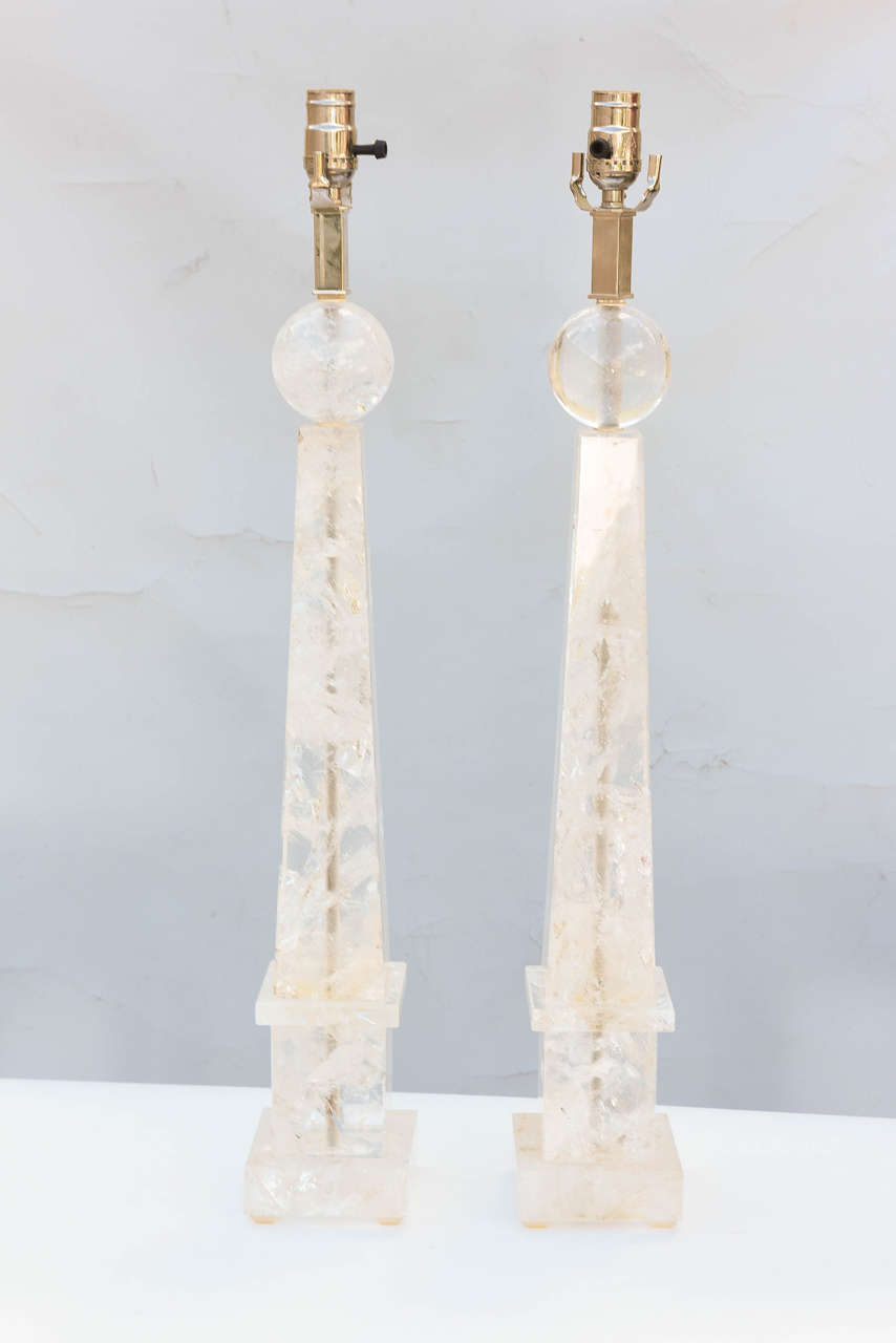 Pair of table lamps, of carved rock quartz crystal. Each lamp in obelisk form, surmounted by a sphere.

Stock ID: D4791.