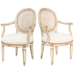 Paire de fauteuils peints et partiellement dorés du 19ème siècle