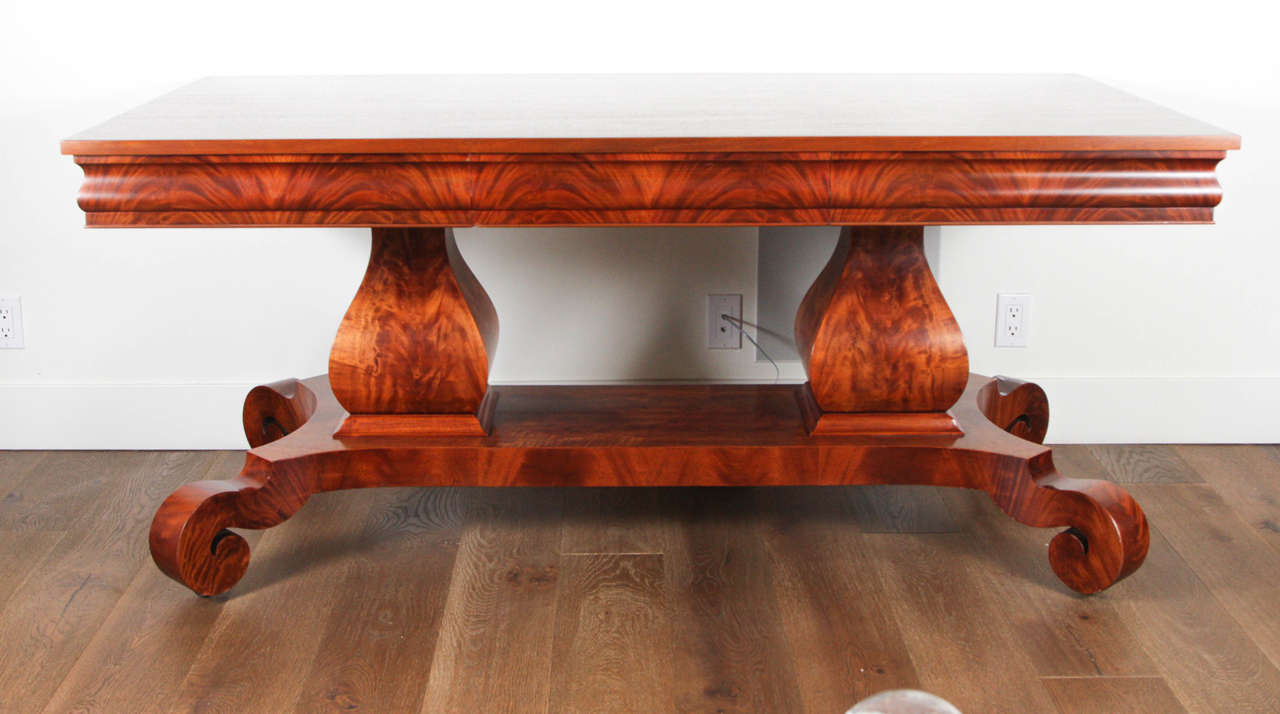 J. & J.W. Meeks and Sons (New York) Attributed library table, circa 1830.

This is a rare form and the crotch mahogany from Honduras is spectacular.

In Empire style with double pedestal base, lower shelf and scroll feet on casters.

 One single