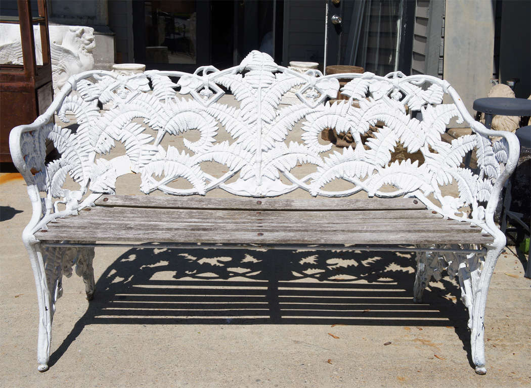 Cast iron painted fern leaf motif English Metal garden bench with wood slat seats.  Wonderful aged wear.