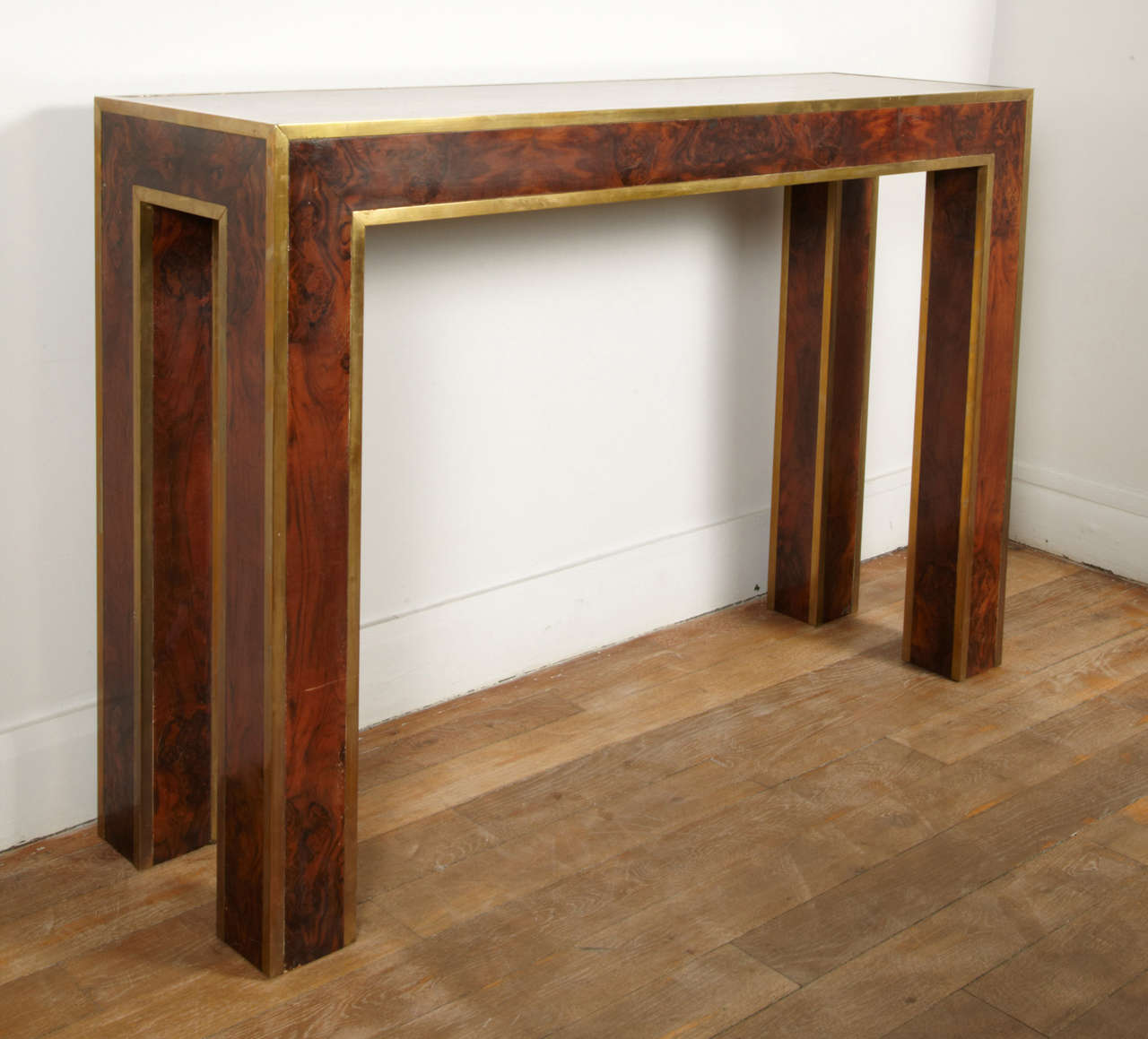 Console table in burr walnut with bronze edges
1970