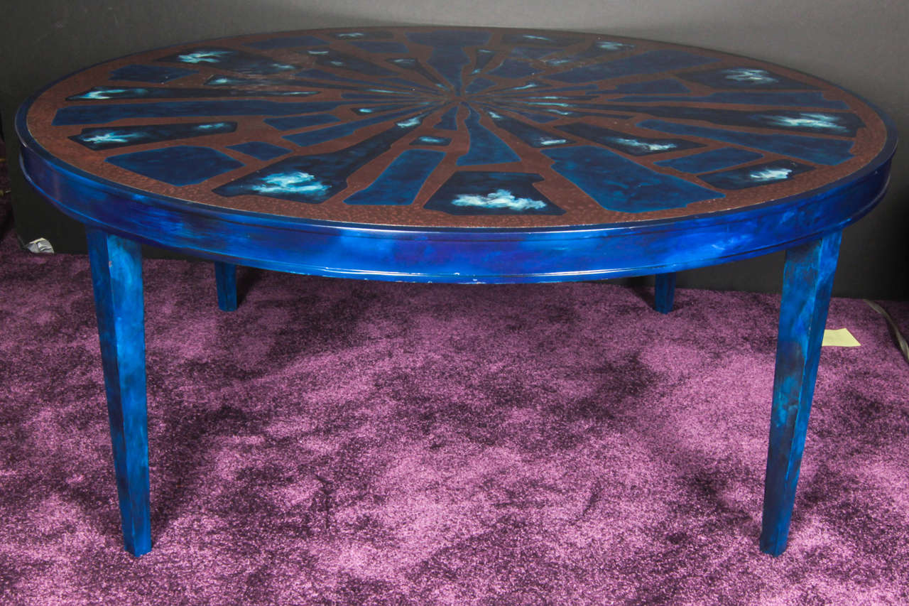 Beautiful and peculiar etched brass and cloudy blue lacquered coffee table. 
The shear size of the table in addition to its cloudy blue tones increases its originality. 

This French coffee table resembles the style of Wily Daro.