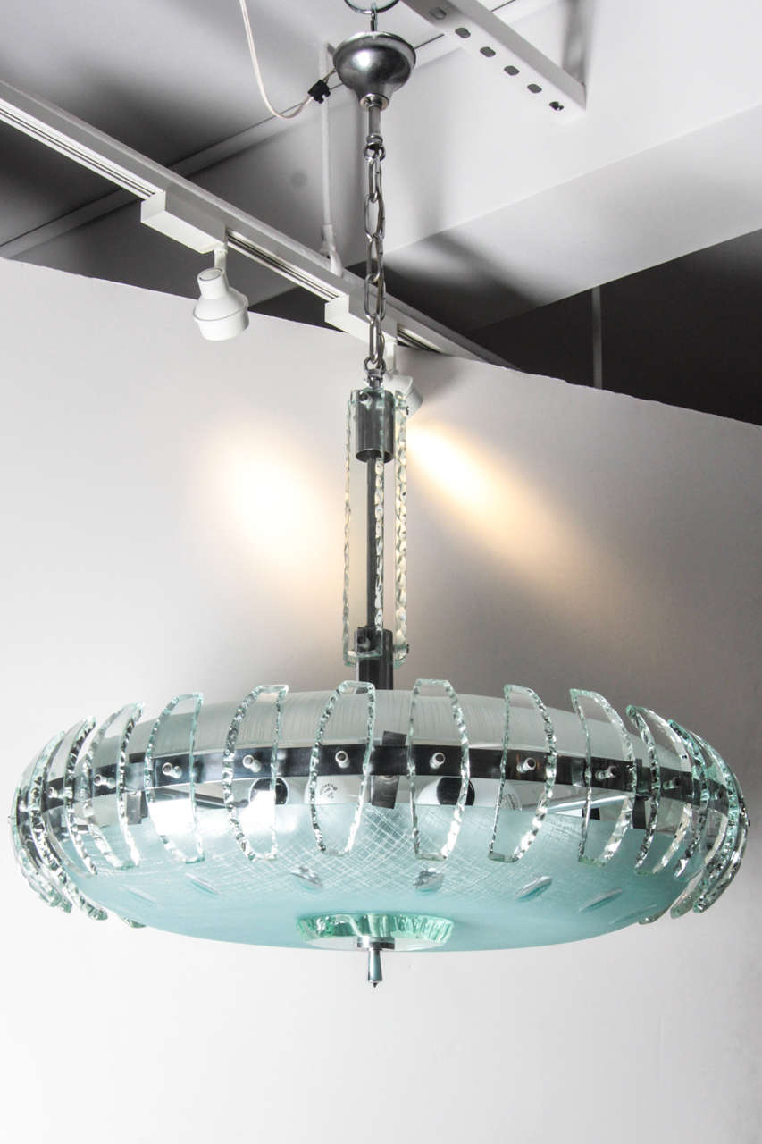 Magnificent probably Fontana Arte chandelier. 

This solid glass and steel circular chandelier is in perfect condition, not a single scratch or default. This is quite rare.

It has just been rewired to current standards.