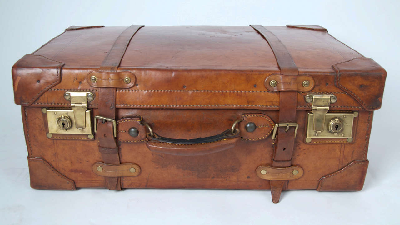 This is a high quality English SUITCASE made in the 19th Century 

The case is Leather which now has a superb patination and colour.

It is very well made with thick leather, excellent stitched detail, brass rivets, strengthened corner pieces