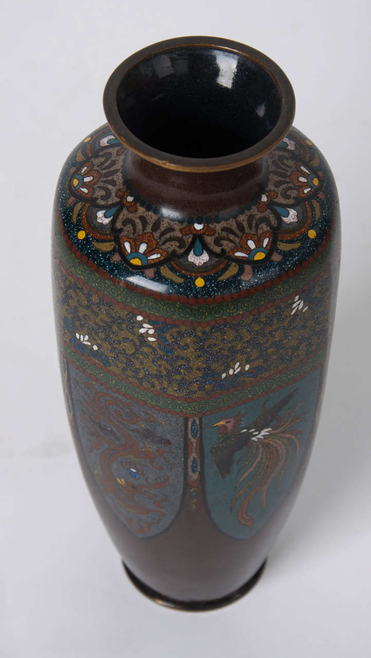 This is a fine quality Meiji period Cloisonné vase, attributed to the workshop of Hayashi Kodenji ( 1831 to 1915).

The vase has an elongated ovoid hexagonal form with a collared neck and bronze rims. 

It is beautifully decorated with peacocks