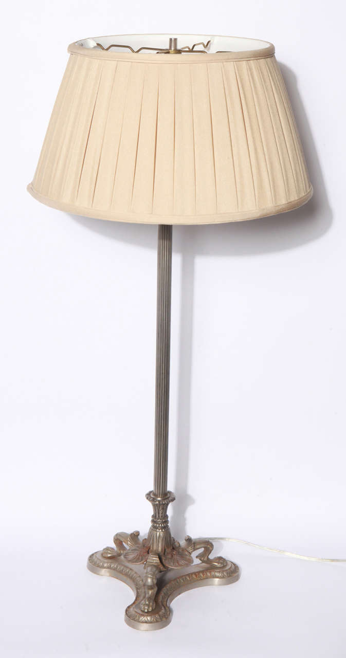 Pair of steel candlesticks have been converted to lamps.  Claw foot detail on base of lamps.  Beige, pleated, fabric shades.