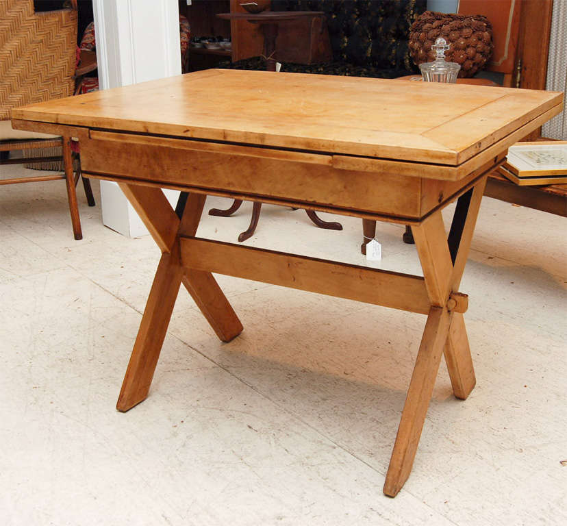 American Maple Trestle Table in a wonderful color and finish. Each end has a 8 inch pull out extension leaf.    When opened the Table measures 58 inches long.