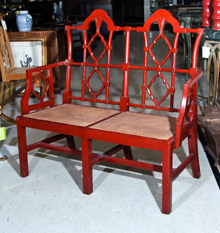 Perfect for a beach home or sunny screened-in deck, this cheerful, attractive Chippendale style bench boasts of an eye-popping cherry red and superb cane seat.