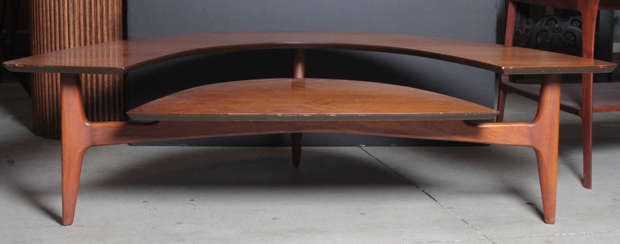 Unusual form two tier walnut coffee/cocktail table with original label.