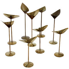 Set of nine brass candle sticks by Kenneth Clark