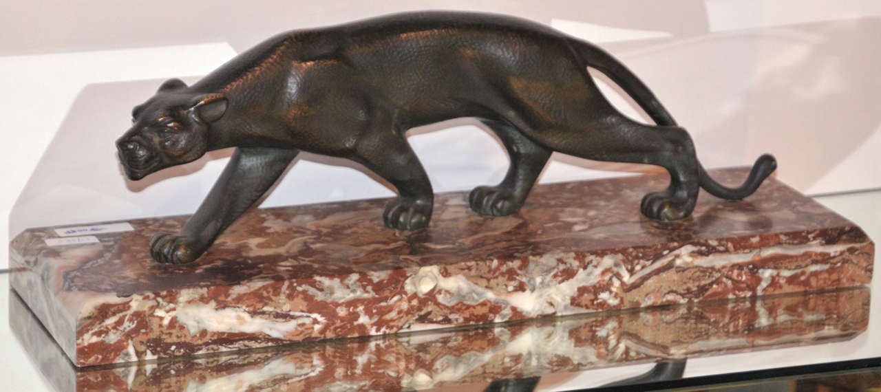 Circa 1930s brown patina bronze sculpture of a striding panther by S. Melani, signed , set on a marble base.