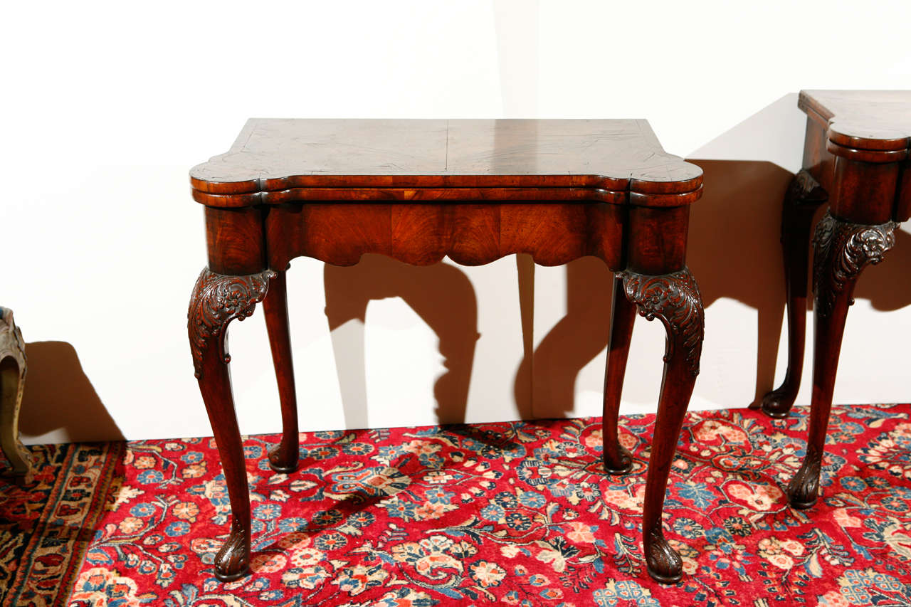 Pair of hand carved Mahogany games tables with vibrant needlepoint interiors featuring birds, butterflies, and flowers.