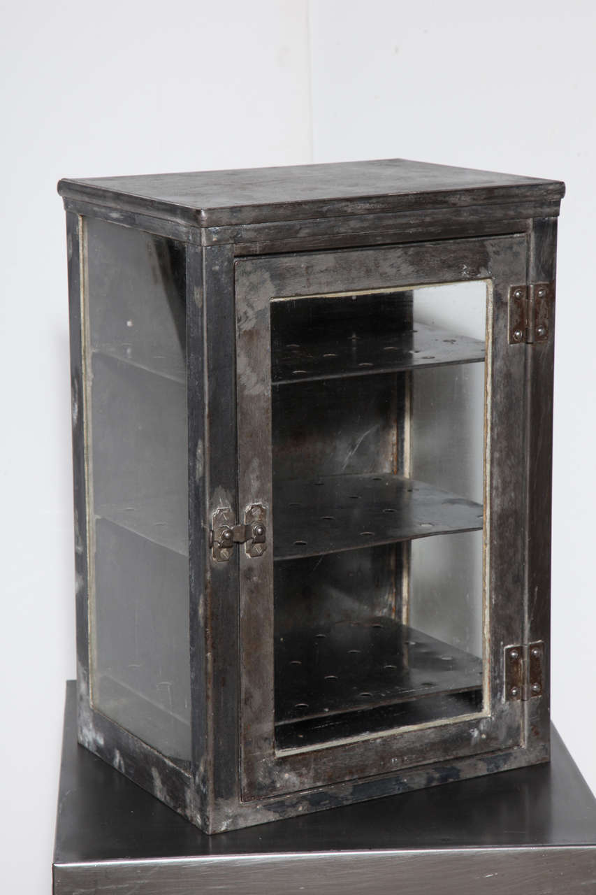 early 20th Century Doctors Sterilizer - Medicine Cabinet.  
The 3 sided Glass Cabinet includes 3 adjustable perforated metal shelves and latch closure.  Fantastic multi use storage cabinet.  Perfect as Bathroom Cabinet, Spice Cabinet, Display