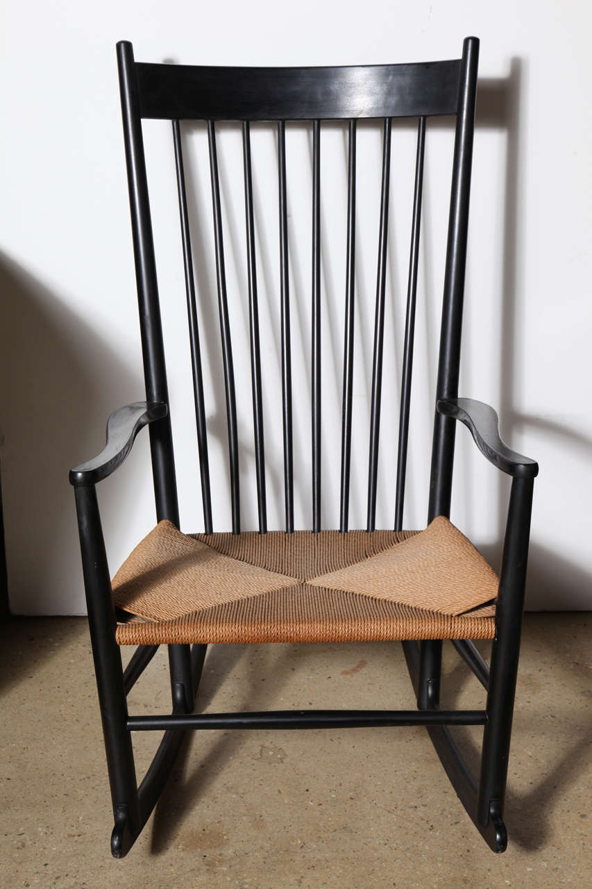 early and very comfortable Danish Modern spindle back Rocker by Hans Wegner for FDB Mobler in ebonized Beech with 3 ply Hemp seat.  
Accompanied with original Black wool cushion and headrest (foam interior replaced) not included at time of