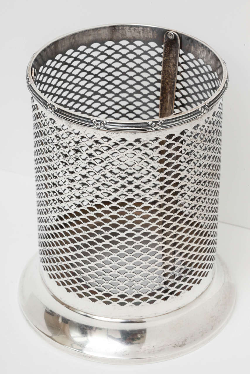A sterling silver wine bottle holder with interesting fan shaped mesh design. Nicely detailed at top rim. This piece holds a wine bottle but is even large enough for champagne bottles. Marked 