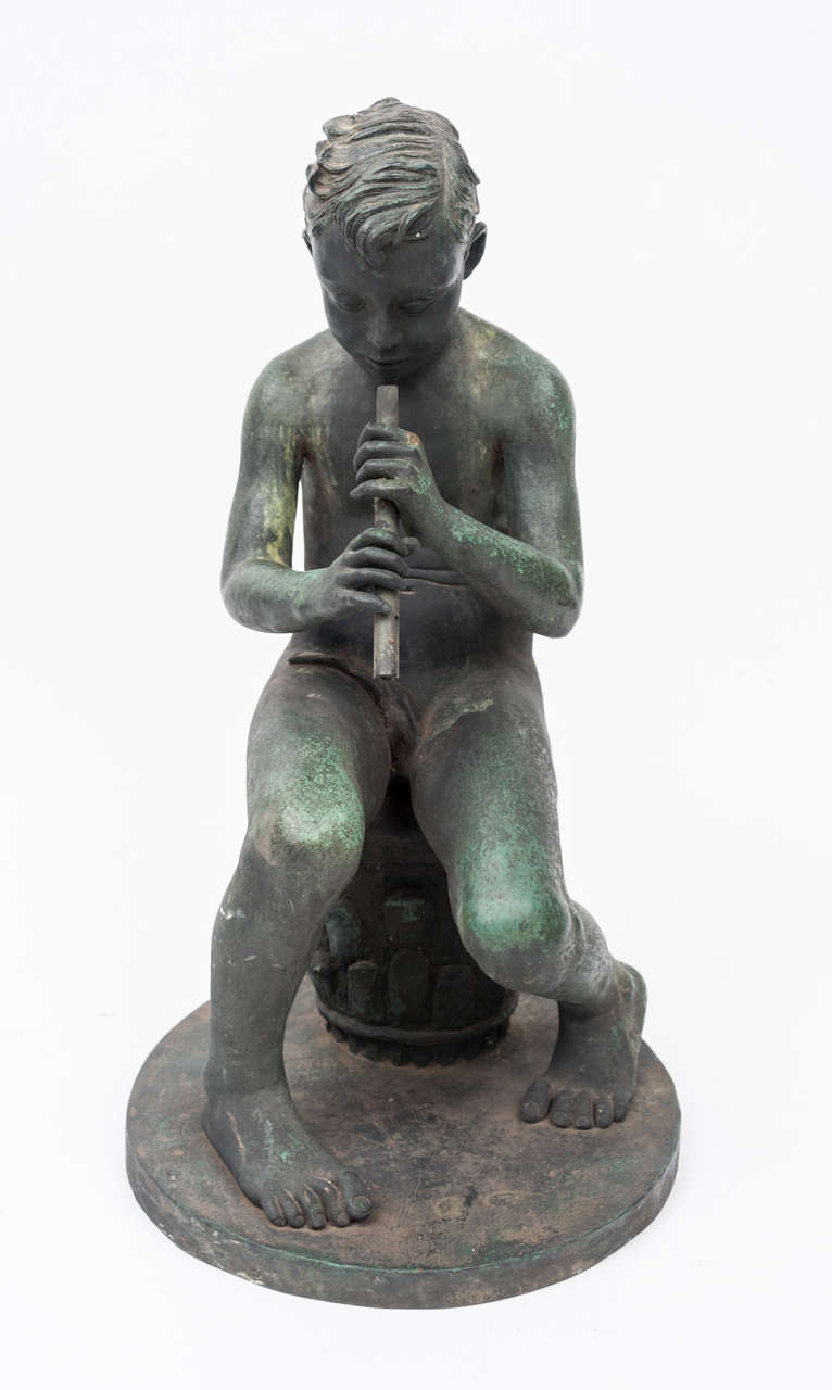 20th Bronze sculpture of young boy, seated on a corinthium capital, playing his flute.  Marked DM Thrupp, Florence 1939.  Good patina.