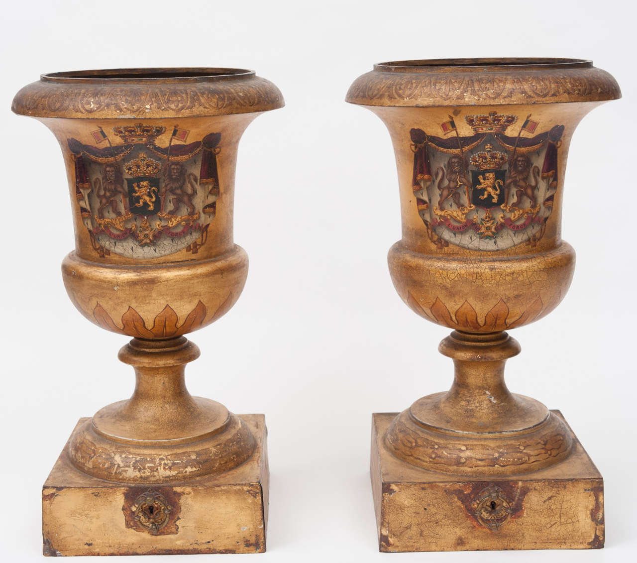 Rare pair of large tole campana shaped urns, with original decoration depicting the Coat of Arms of the Belgian Royal Family.  Very finely painted on a gold background.  The plinth bases incorporating a drawer.