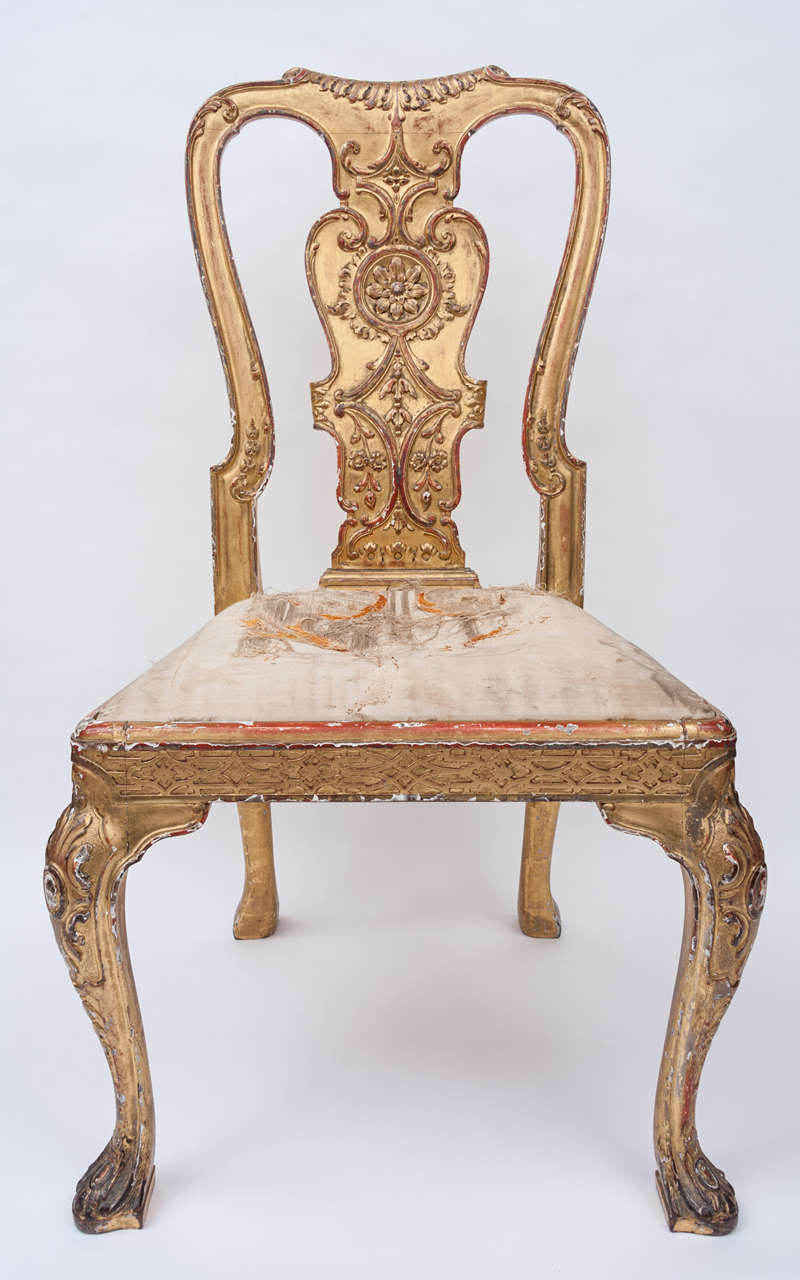 An excellent quality, George I style gilt wood and gesso side chair, in the style of James Moore.  The shaped back incorporating a wide splat with carved paterae strap work and foliage.  The drop in seat, within a frame of blind fret detail, raised