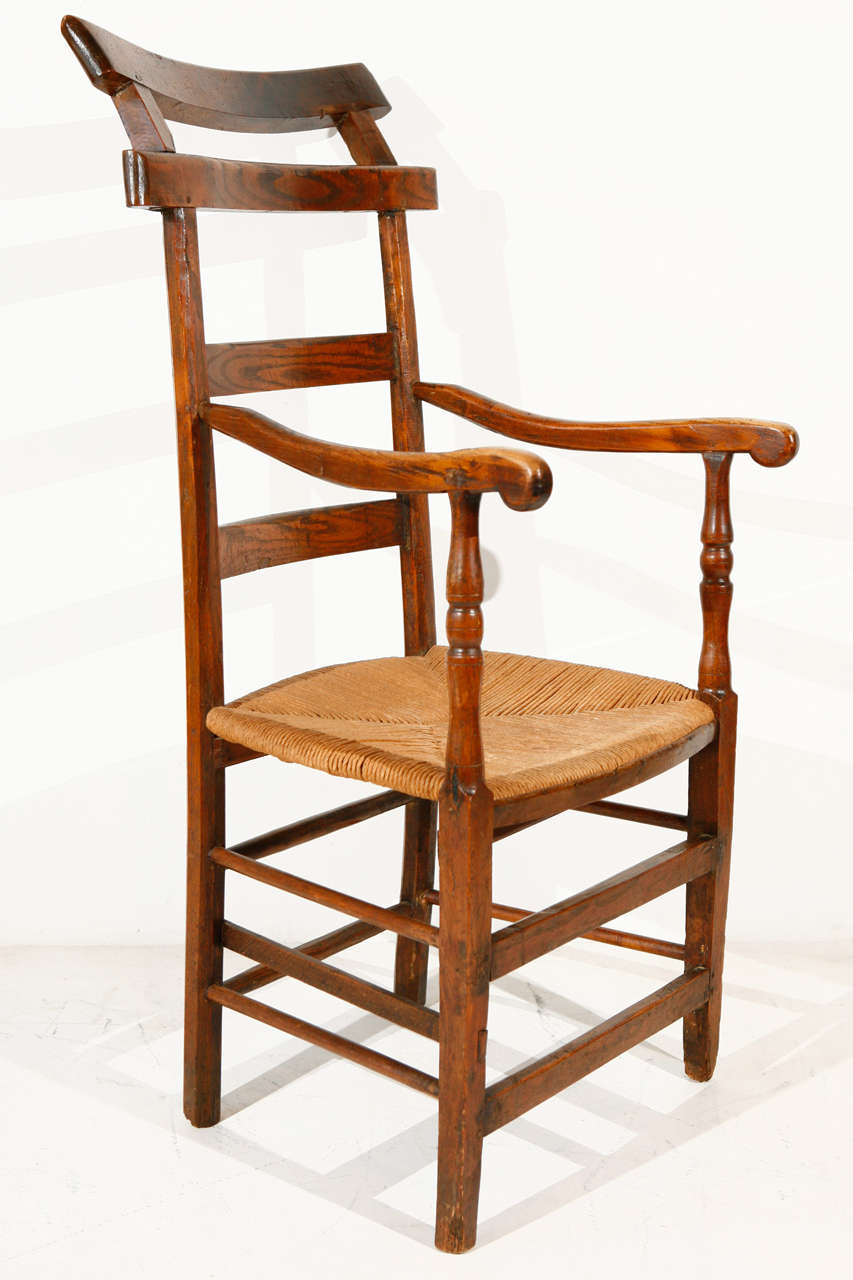 Sculptural elm and oak wood chair. Newly rushed seat.