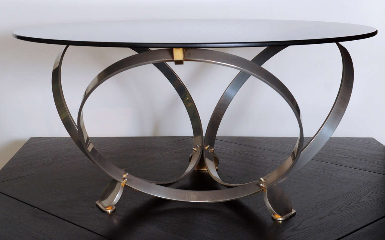 Wonderful Italian coffee- or sidetable with a smoked glass top on a base of 3 rings and nicely shaped feet. 