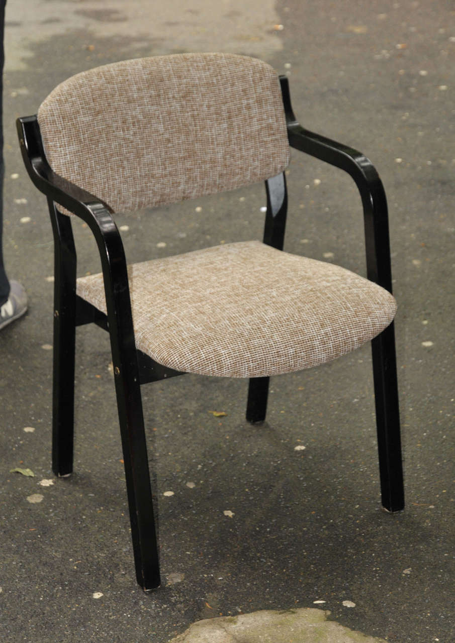 Three 1960s armchairs with structure in black wood; reupholstered in cotton fabric.
