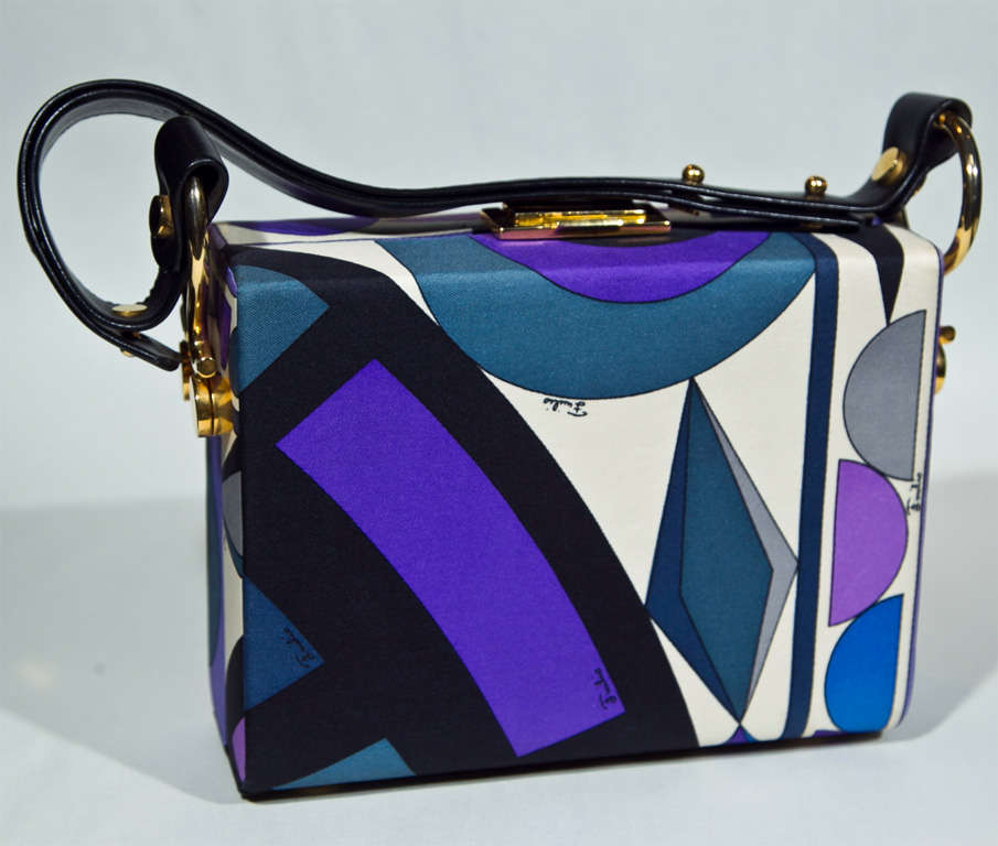 This signed superb modernist motif piece represents one of the finest examples of Emilio Pucci signature prints we've seen. (primo vintage Pucci: our forte) Brilliant brass hardware & a sleek black leather strap add panache. This is worthy as a