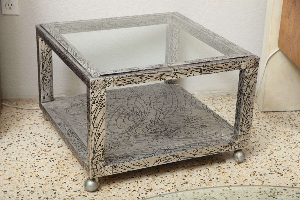 Delightfully, doodle-y, glass-topped table by Palm Beach artisan, Marvin Arenson. Sheathed metal over wood, with whimsical, galactic-inspired, hand-wrought repousse designs. Artist signed.